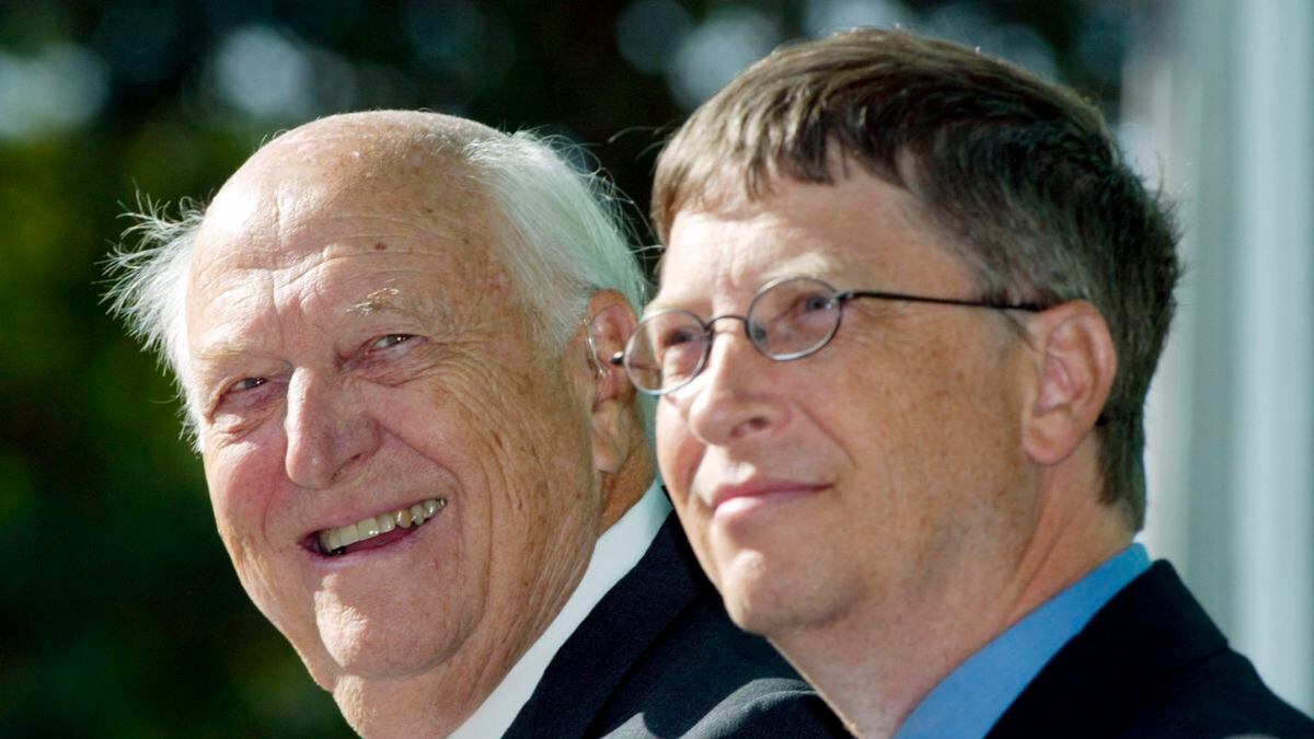 FILE - In this Sept. 12, 2003 file photo, William H. Gates Sr., left, smiles while sitting next to his son, Bill Gates Jr., during the dedication and grand opening of the William H. Gates Hall, new home of the University of Washington School of Law in Seattle. Bill Gates Sr., a lawyer and philanthropist and father of Microsoft co-founder Bill Gates, died Monday, Sept. 14, 2020, at age 94.