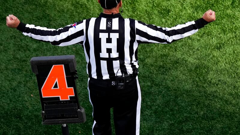 An official motions while standing by a down marker during the first half of an NCAA college...