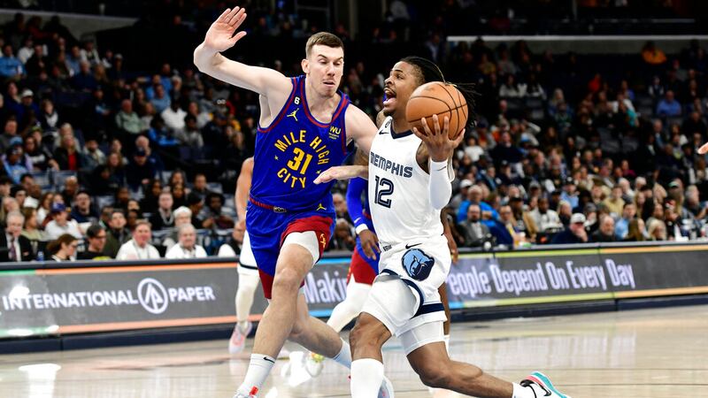 Memphis Grizzlies guard Ja Morant (12) drives against Denver Nuggets forward Vlatko Cancar...