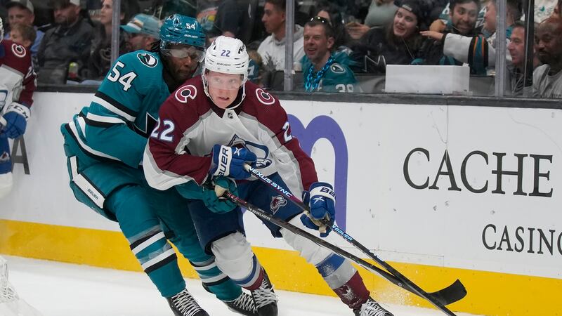 Colorado Avalanche center Fredrik Olofsson (22) skates with the puck against San Jose Sharks...