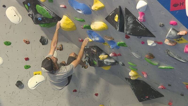 Andrew Bellisle, one of the owners of Black Hills Basecamp climbs a route in his gym.