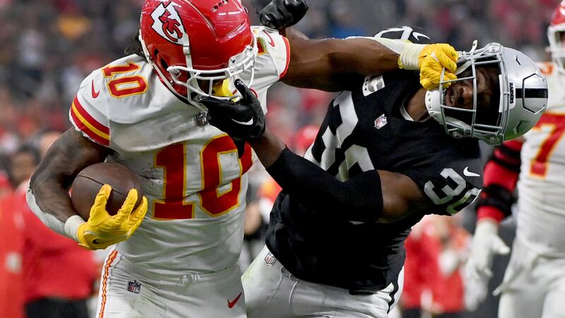 Kansas City Chiefs running back Isiah Pacheco (10) struggles for yardage as Las Vegas Raiders...